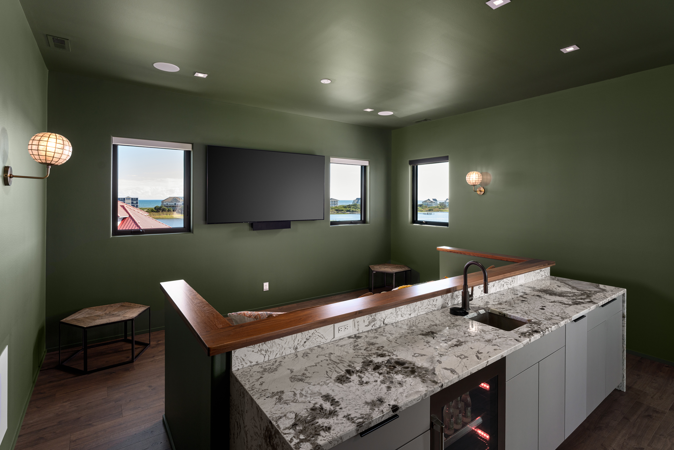 Media lounge with wet bar and water views