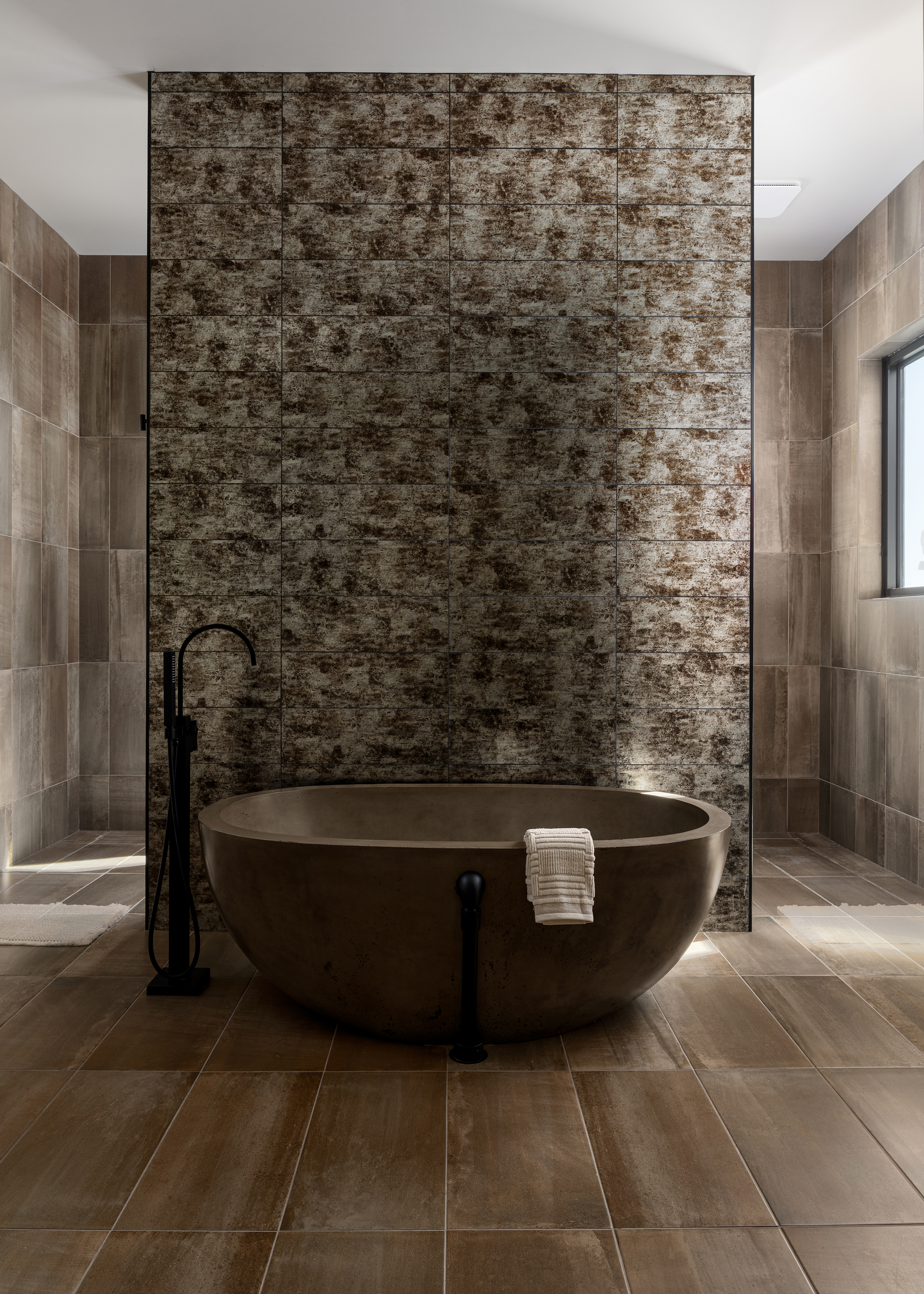 Freestanding soaking tub in primary bath